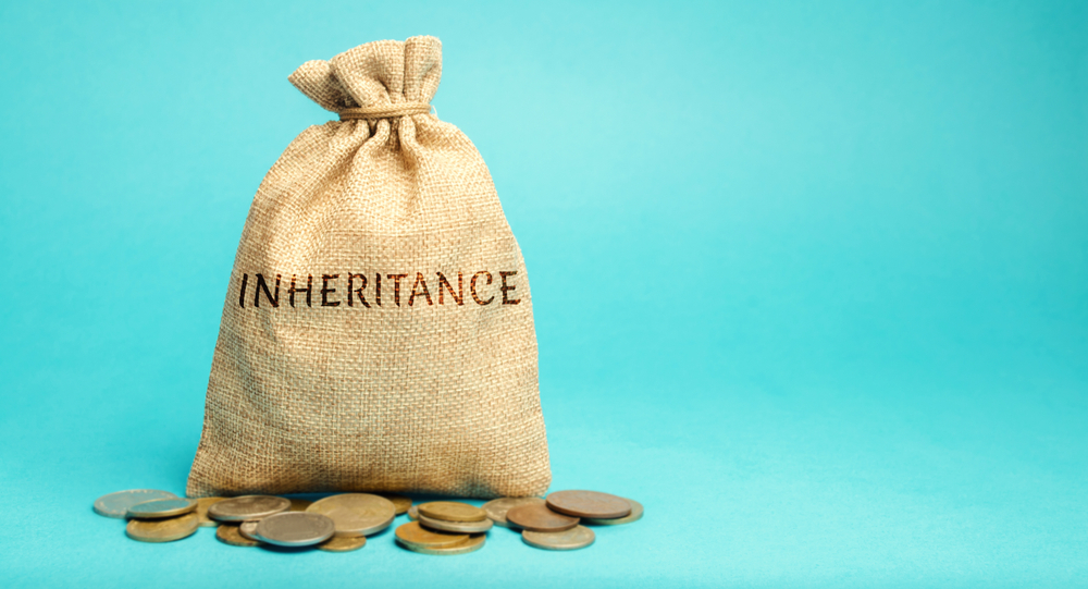 A bag full of money labeled with the word inheritance.