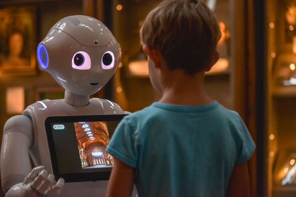 robot interacting with young caucasian boy